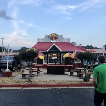 R'Jabs Wings - a man walking in front of a restaurant - Chicken Wings Near Me - Austell, Georgia R'Jabs Wings - a man walking in front of a restaurant - Chicken Wings Near Me - Austell, Georgia