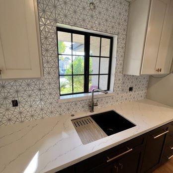 Alvarez Tile - notice how the pattern is completely aligned on both ends of the window and centered on the location for sconce above the window - General Contractors Near Me