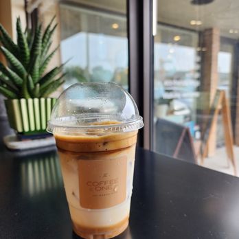 The Coffee One - a cup of coffee on a table - Coffee & Tea Near Me - Winnipeg, Manitoba