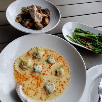 Plate - Parmesan broth ravioli, crispy brussels, and broccolini - Cocktail Bars Near Me - Kansas City, Missouri Plate - Parmesan broth ravioli, crispy brussels, and broccolini - Cocktail Bars Near Me - Kansas City, Missouri