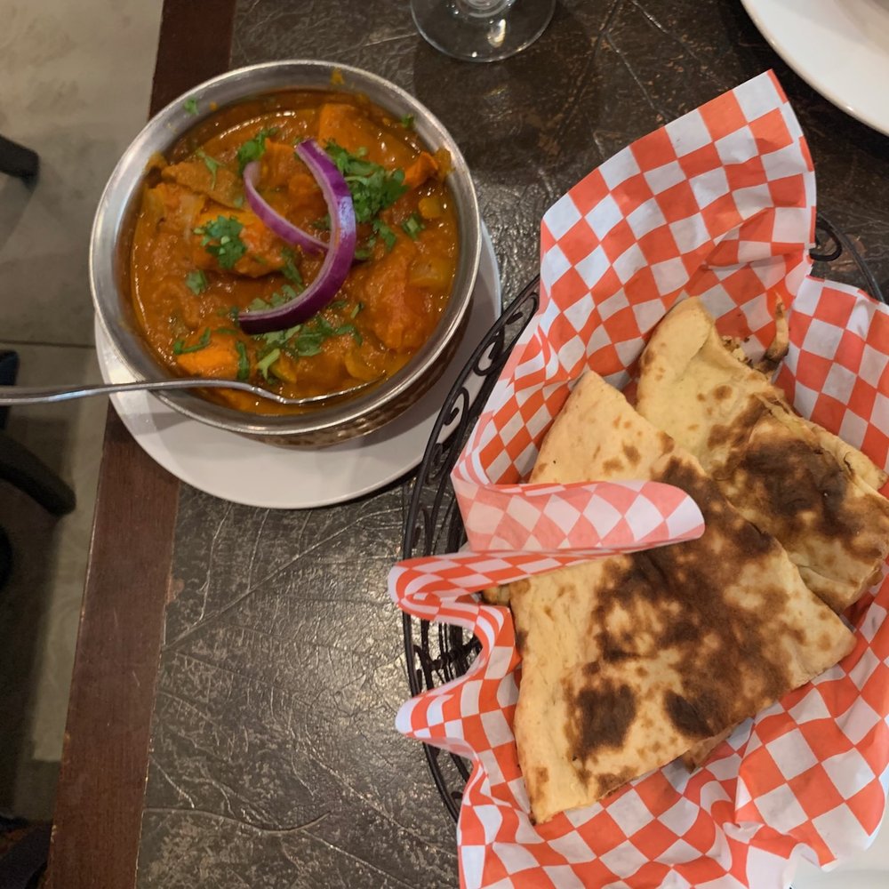 a bowl of soup and a pita sandwich