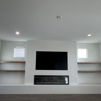 All Pro Remodeling - Media wall, electric fireplace, TV, wood shelving, seated bench, fresh paint - General Contractors Near Me