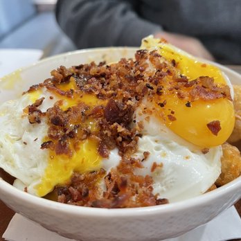 Early Bird Shadow Lake - Tot Poutine, a bowl of crispy tator tots, breaded cheese curds, sausage gravy, over easy eggs, and real crumbled bacon. - Breakfast & Brunch Near Me - Papillion, Nebraska Early Bird Shadow Lake - Tot Poutine, a bowl of crispy tator tots, breaded cheese curds, sausage gravy, over easy eggs, and real crumbled bacon. - Breakfast & Brunch Near Me - Papillion, Nebraska