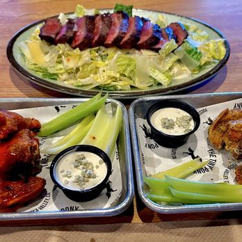 The Tiny Pony - Ceaser Salad with Flat Iron steak. And Pony Wings, 1/2 buffalo sauce and 1/2 lemon pepper. With celery and blue cheese dressing - Bars Near Me - Yucca Valley, California