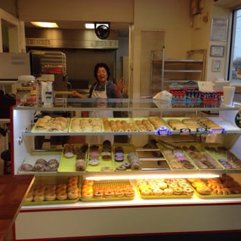 Maple Donuts - a woman behind the counter of a donut shop - Donuts Near Me - Carrollton, Texas