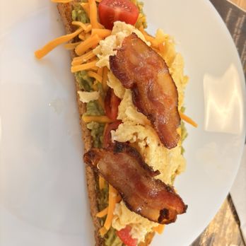 Cafe Warao - Americano Avocado toast with scrambled egg, cheese, cherry tomatoes and bacon  on the menu  Warao Avocado Toast, only $9.95. - Breakfast & Brunch Near Me - Suisun City, California