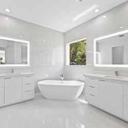 Take a look at this bathroom, featuring the Hudson Vanity Collection, custom countertops, and Hotel LED Mirrors.