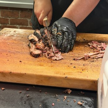The Original Roy Hutchins Barbeque - Cutting the brisket - Barbeque Near Me - Arlington, Texas The Original Roy Hutchins Barbeque - Cutting the brisket - Barbeque Near Me - Arlington, Texas