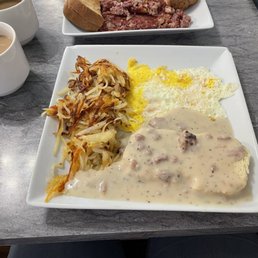 Biscuits & Gravy with hash browns and fried eggs. Biscuits & Gravy with hash browns and fried eggs.