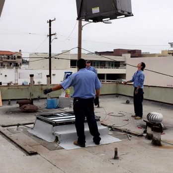 Evenflow Mechanical - A crane places a new York package unit on the roof of a local business. - Heating & Air Conditioning/HVAC Near Me - Lomita, California Evenflow Mechanical - A crane places a new York package unit on the roof of a local business. - Heating & Air Conditioning/HVAC Near Me - Lomita, California