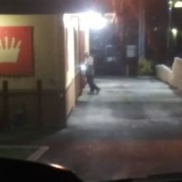 a person walking down a street at night