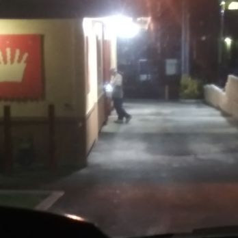 Del Taco - a person walking down a street at night - Mexican Near Me - Norco, California