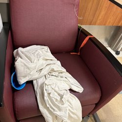 Staten Island University Hospital North Campus - Throw up bag, old IV, dirty blanket on the chair next to me.