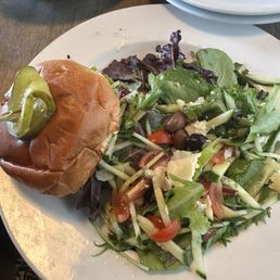 Chicken sandwich with tasty side salad.
