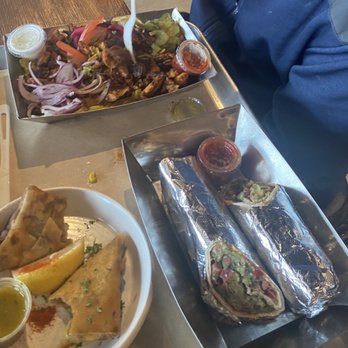 Mazra - Top: chicken shawarma plate Left: sambusas Right: falafel lavesh wrap - Middle Eastern Near Me - San Bruno, California Mazra - Top: chicken shawarma plate Left: sambusas Right: falafel lavesh wrap - Middle Eastern Near Me - San Bruno, California