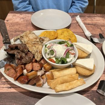 Sofrito Latin Cafe - Picada for two: steak, chicken, pork belly, sausage, tostones (fried plantain), fried yuca, mini arepas, queso de mano, salad - Latin American Near Me - Orlando, Florida Sofrito Latin Cafe - Picada for two: steak, chicken, pork belly, sausage, tostones (fried plantain), fried yuca, mini arepas, queso de mano, salad - Latin American Near Me - Orlando, Florida
