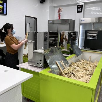 Sweet Saigon - a woman in a kitchen preparing food - Juice Bars & Smoothies Near Me - Grand Prairie, Texas