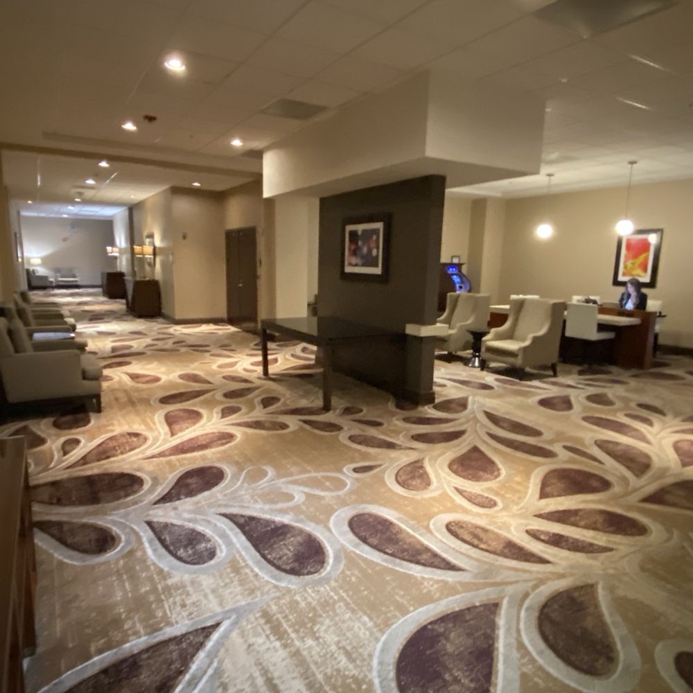 Hilton Concord - Another section of the first floor where the meeting rooms are located... the loose electrical plate is located where that lady is sitting - Hotels Near Me - Concord, California