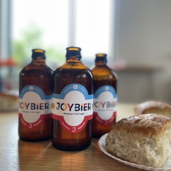 Joyland - a plate of bread and bottles of beer - New American Near Me - Nashville, Tennessee