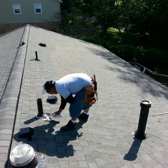 Optimum Contractor - a man working on a roof - General Contractors Near Me - Sterling, Virginia Optimum Contractor - a man working on a roof - General Contractors Near Me - Sterling, Virginia