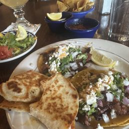 Mini tacos, pastor quesadillas, fixings, chips, salsa, and the house margarita. Mini tacos, pastor quesadillas, fixings, chips, salsa, and the house margarita.