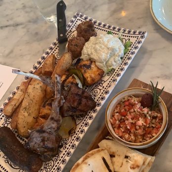 Stella's - Sampler special (lamb lollypop, lamb meatballs, chicken skewers, sausage, tzatziki, potatoes) with side of tabouleh - Mediterranean Near Me - Richmond, Virginia