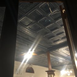 Root Cellar - Beautiful restored, pressed tin ceiling and support post of The Root Cellar.