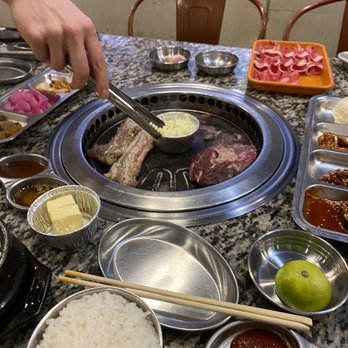 Let's Meat Kbbq - Our waiter helped us cook the pork and other meat periodically in between tables. Told us how long to cook pork too! - Korean Near Me - Charlotte, North Carolina