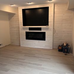 Complete Construction - Custom built electric fireplace with entertainment system and television