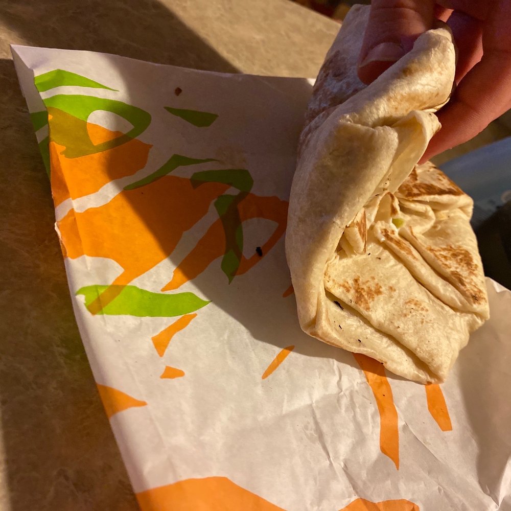 a hand holding a piece of food a hand holding a piece of food