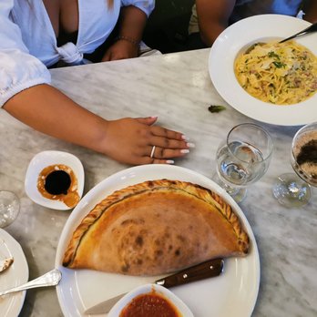 Vagabondo Restobar - Calzone versus hand for comparison - Italian Near Me - Toronto, Ontario