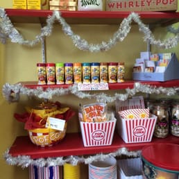 a shelf of popcorn and other snacks a shelf of popcorn and other snacks