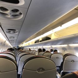 American Eagle Airlines - Plenty of room above still, but would not allow us to bring carry ons at ANY cost.