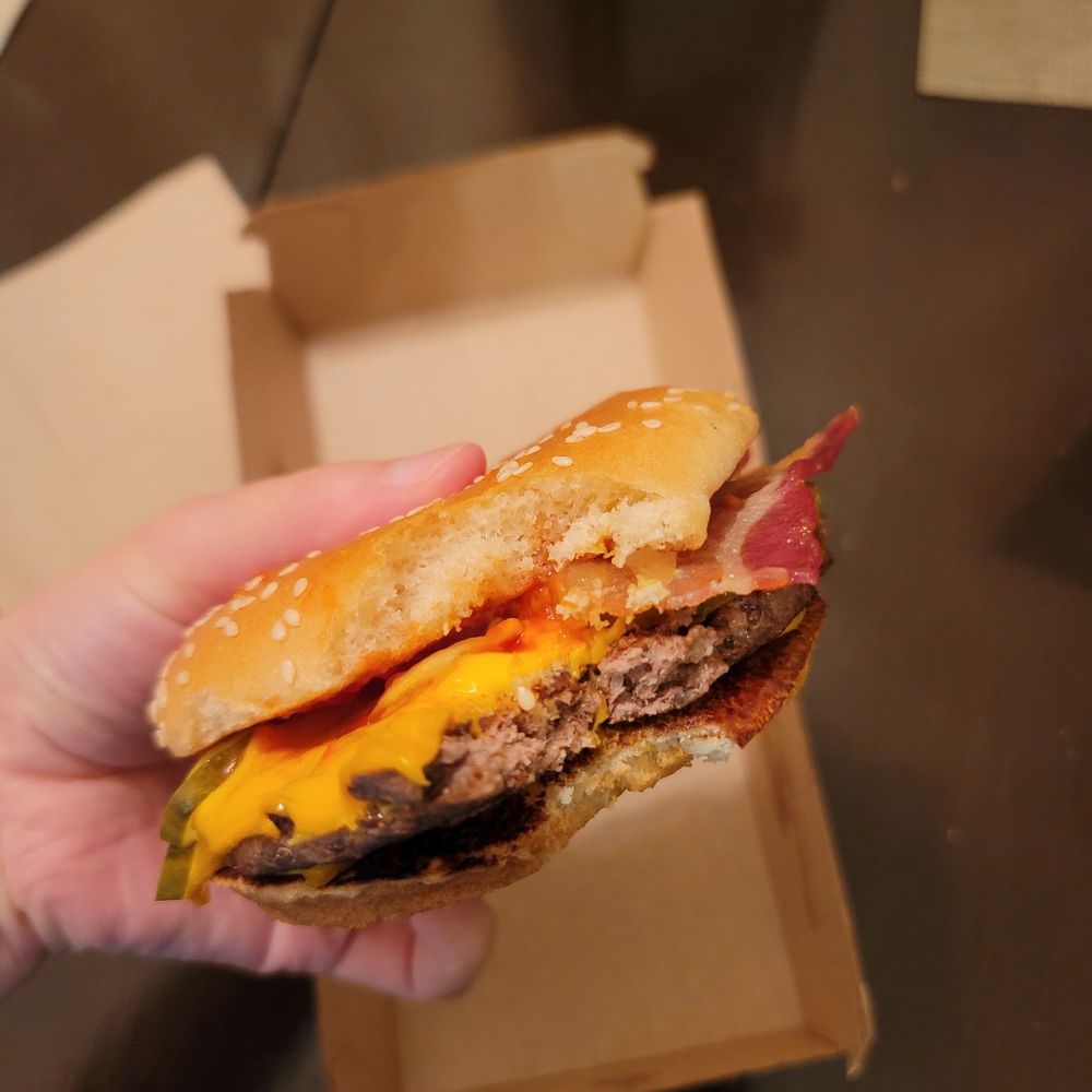 McDonald's - a hand holding a cheeseburger - Fast Food Near Me - Wylie, Texas McDonald's - a hand holding a cheeseburger - Fast Food Near Me - Wylie, Texas