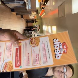 a man holding a pizza box