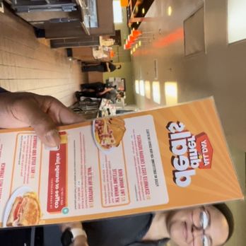 Denny's - a man holding a pizza box - American Near Me - Hesperia, California