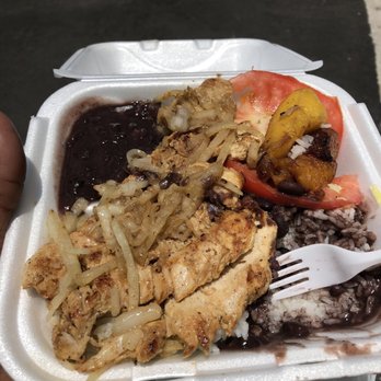 El Doblon - a person holding a container of food - Cuban Near Me - Miami, Florida