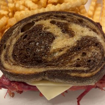 P-Nut Gallery Backroads - Layers of tender corned beef and melted Swiss cheese between perfectly grilled marble rye bread, served with a side of crispy crinkle-cut fr - Seafood Near Me - Taylor, Wisconsin