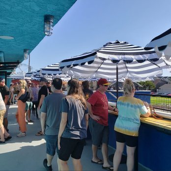 Green Cheek Beer Co. - Ocean view patio with shade and wind guards - Breweries Near Me - Sunset Beach, California
