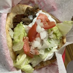 a pita sandwich with lettuce and tomatoes a pita sandwich with lettuce and tomatoes