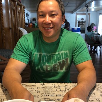 Rail Road Cafe - a man sitting at a table with a cell phone in front of him - Cafes Near Me - Campbellton, Texas
