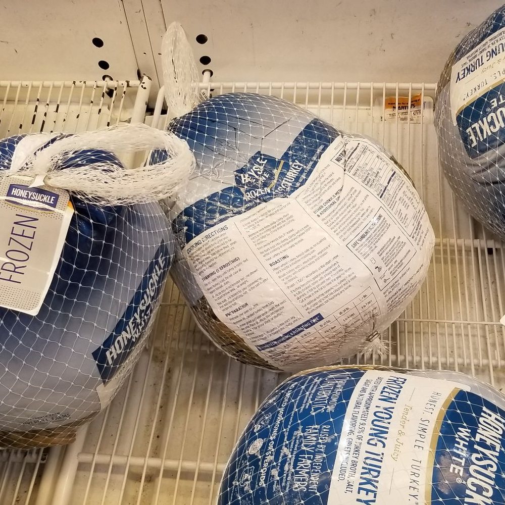 a bunch of frozen meat wrapped in netting a bunch of frozen meat wrapped in netting