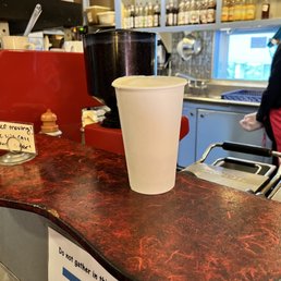 a cup of coffee on a counter a cup of coffee on a counter