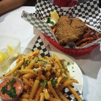 Claws - catfish basket w/ sweet potato fries in back, garlic parmesan fries in front - Cajun/Creole Near Me - Garden Grove, California