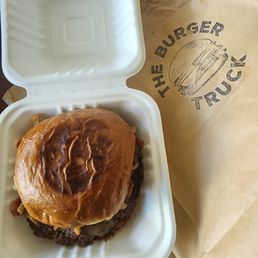 a hamburger in a styrofoam container a hamburger in a styrofoam container
