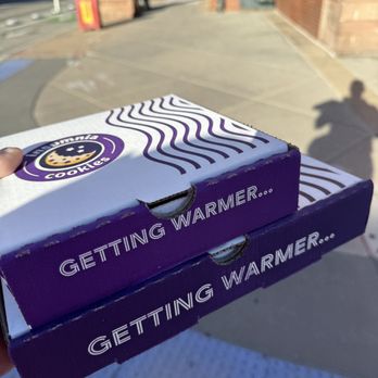 Insomnia Cookies - a person holding two boxes of cookies - Desserts Near Me - Denver, Colorado Insomnia Cookies - a person holding two boxes of cookies - Desserts Near Me - Denver, Colorado