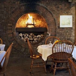 Garden Cafe & Gallery - Beautiful brick, circular fireplace in the main dining room.