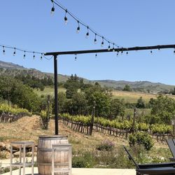 Long Walk Vineyard - Outside patio with view of some of the vineyard, sun and shade places to sit.