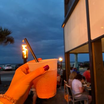 Tortuga's Kitchen & Bar - a person holding a drink - Bars Near Me - Flagler Beach, Florida