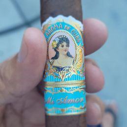 a hand holding a cigar a hand holding a cigar